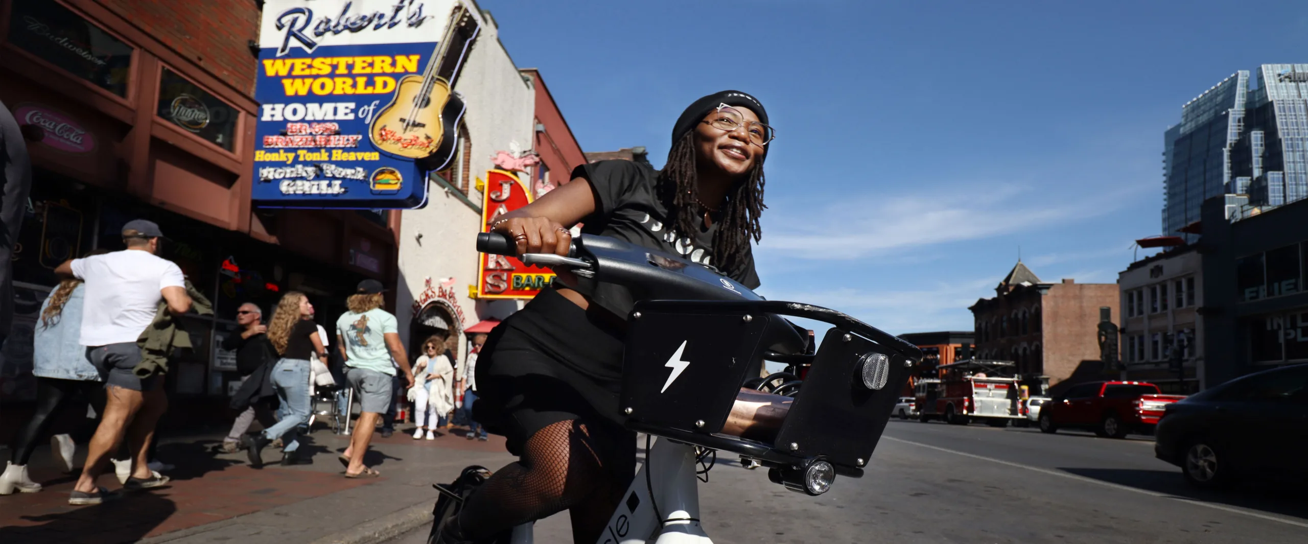 Photo of woman riding a bike share bicycle on Nashville's Honky Tonk Highway