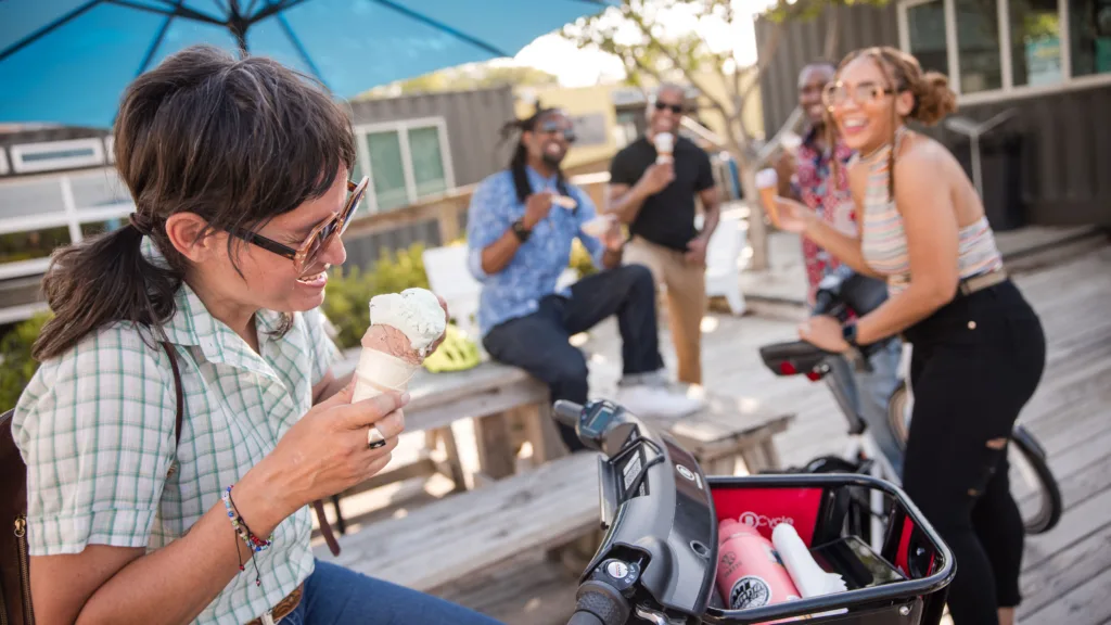 Photo of a group of riders eating ice cream with their bike share bicycles